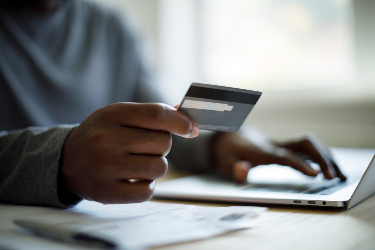 Man using credit card and laptop for online shopping