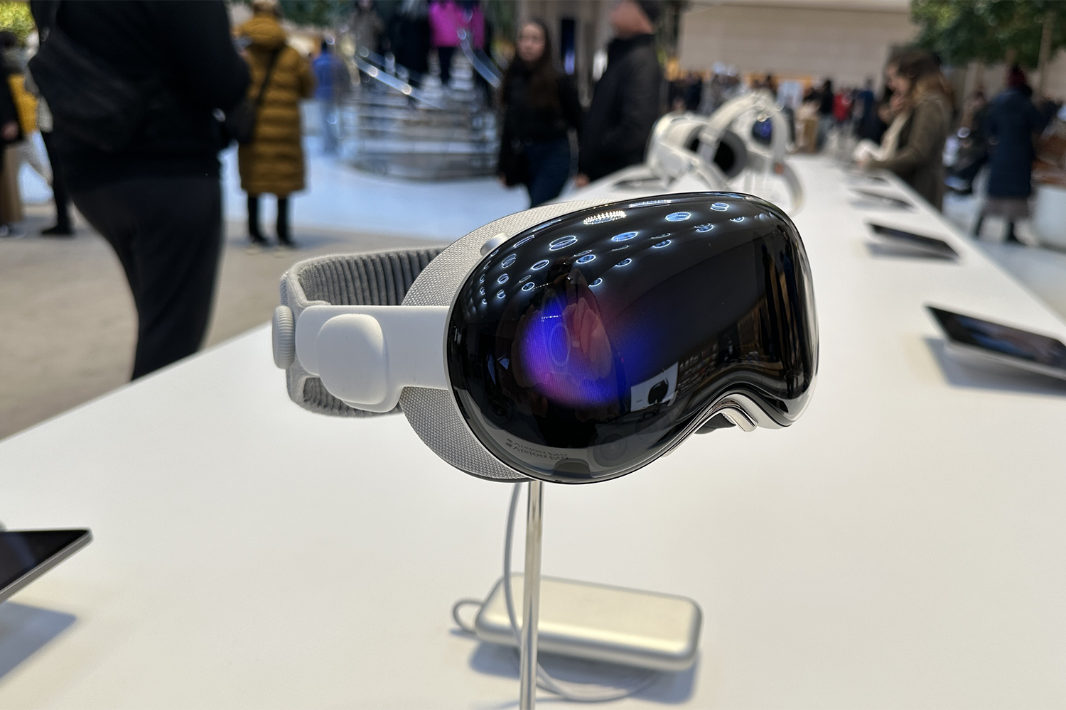 Apple Vision Pro on a stand in an Apple Store. The AVP Gets New AI Features with Apple Intelligence