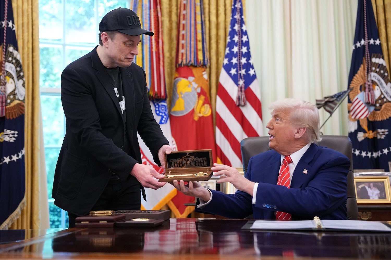 Elon Musk receives a key from U.S. President Donald Trump in the Oval Office of the White House on May 30, 2025 in Washington, DC.